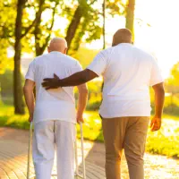 A man and a senior man walking together outside