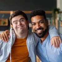 two males putting their arms in each other's shoulders