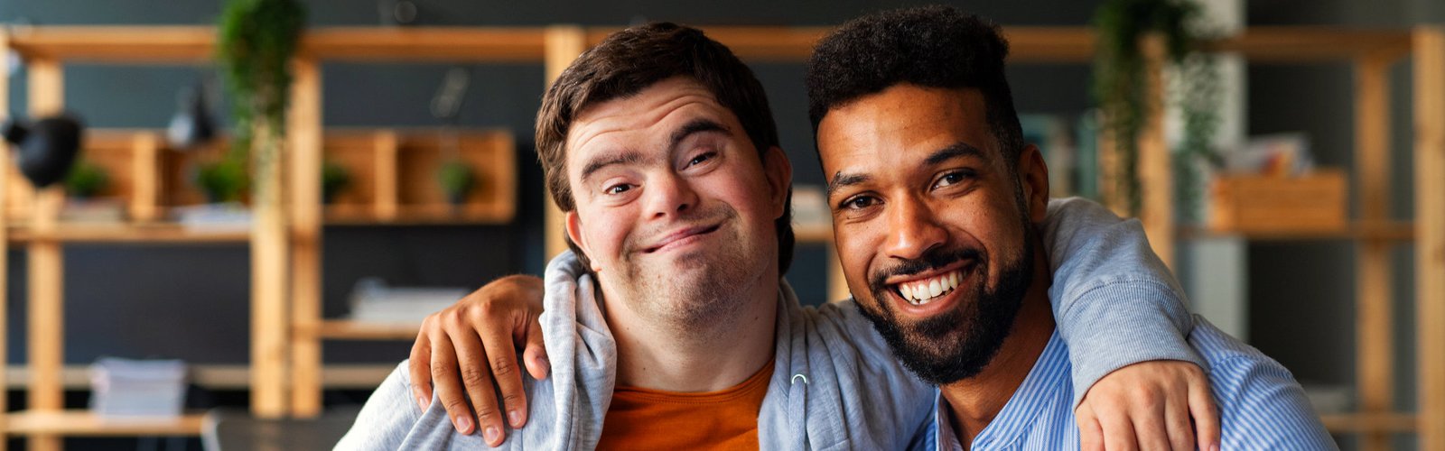 two males putting their arms in each other's shoulders