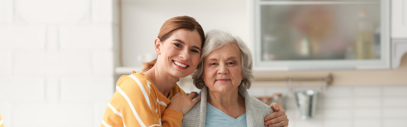 A female hugging a senior woman