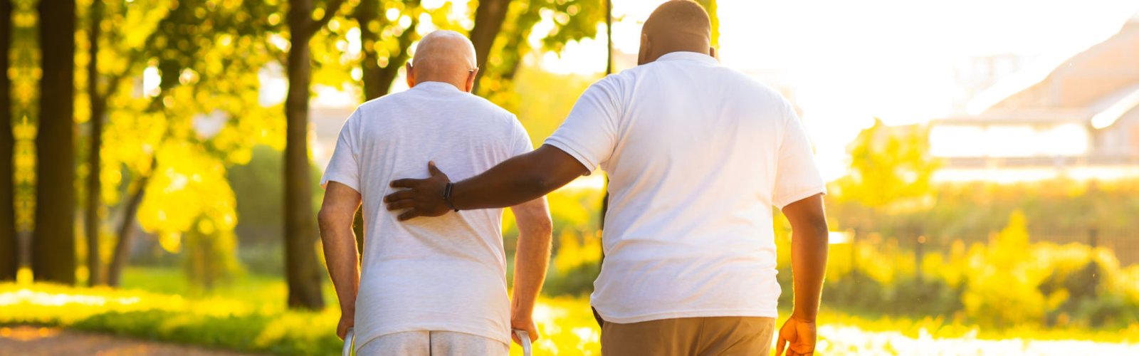 A man and a senior man walking together outside