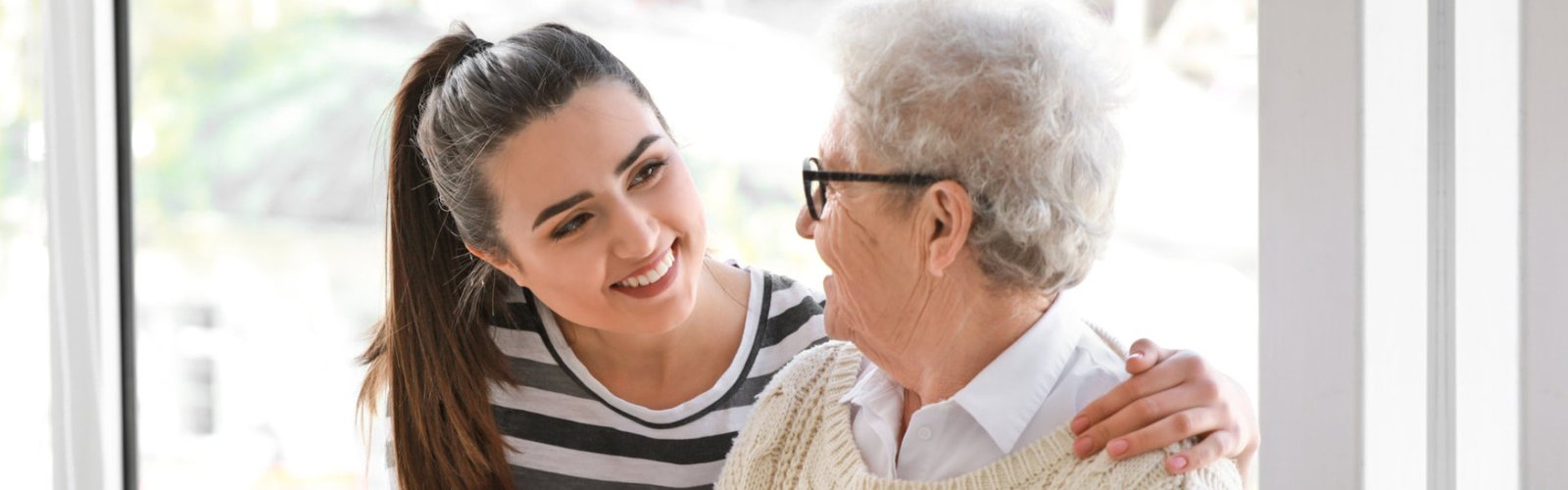 A female and a senior woman looking at each other